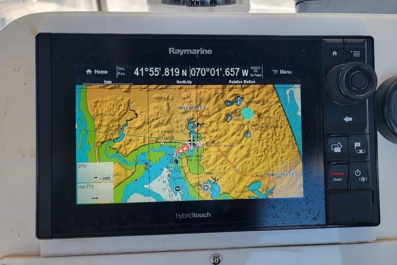 Slide: The Image of Raymarine GPS display on 2004 Stamas 310 Tarpon, showing nautical map and coordinates. - 6