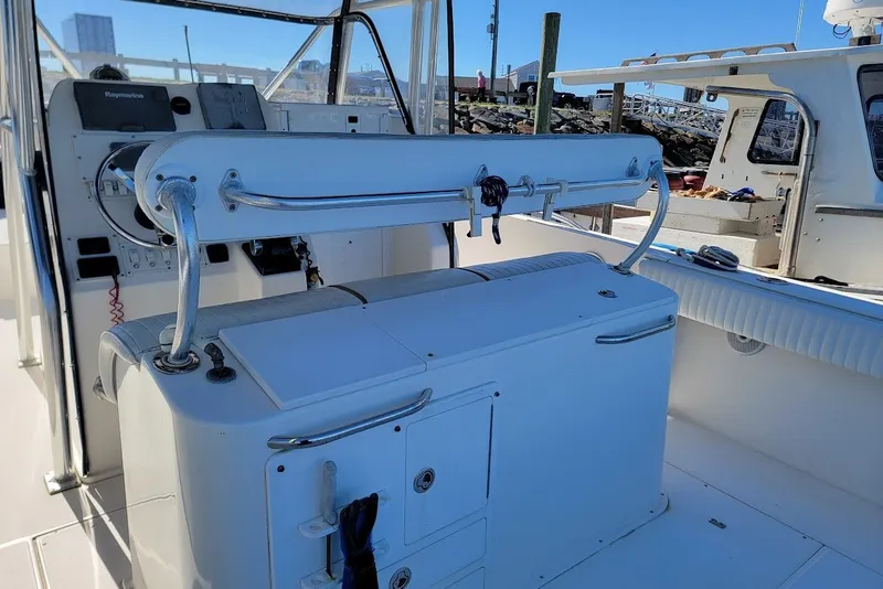 Slide: The Image of 2004 Stamas 310 Tarpon boat interior with control panel and seating area. - 21