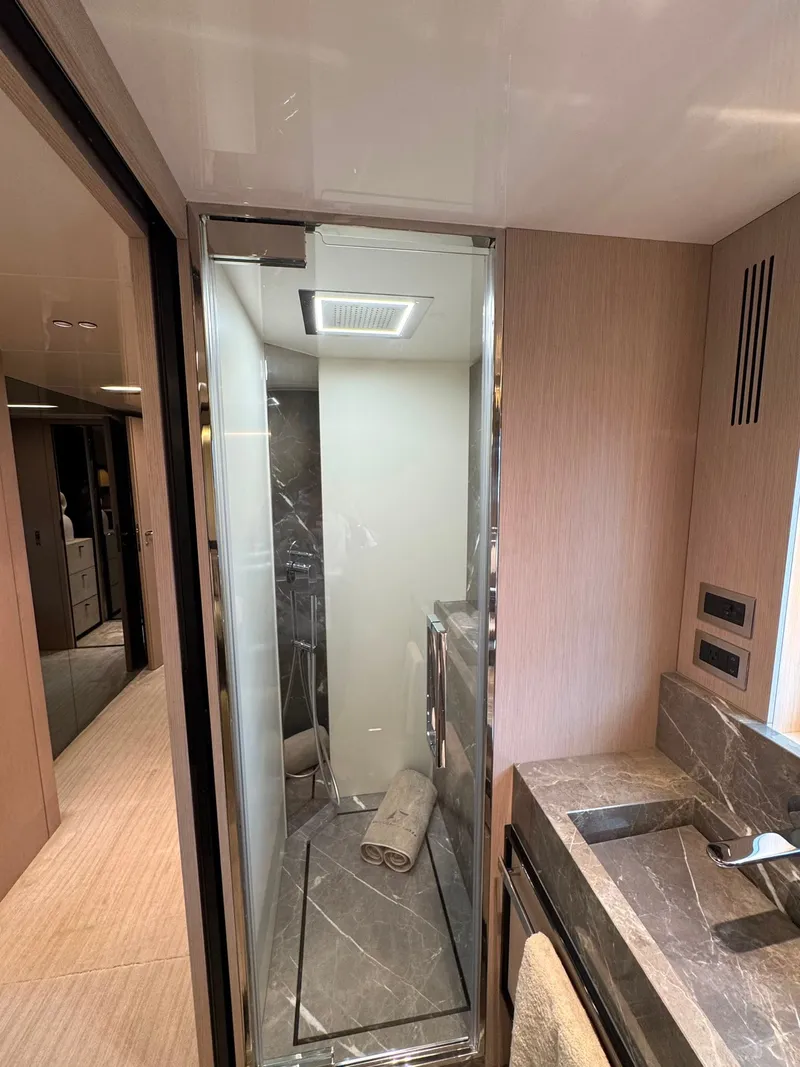 Slide: The Image of Bathroom with modern shower, marble sink, and towels in a luxurious boat. - 32