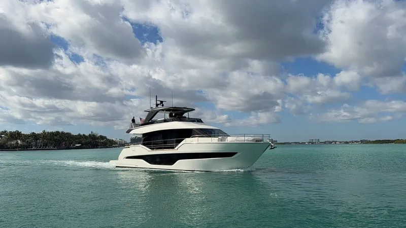 The Image of The 2026 Cranchi Sessantassette 67 cruises on calm waters under a cloudy sky. - 1