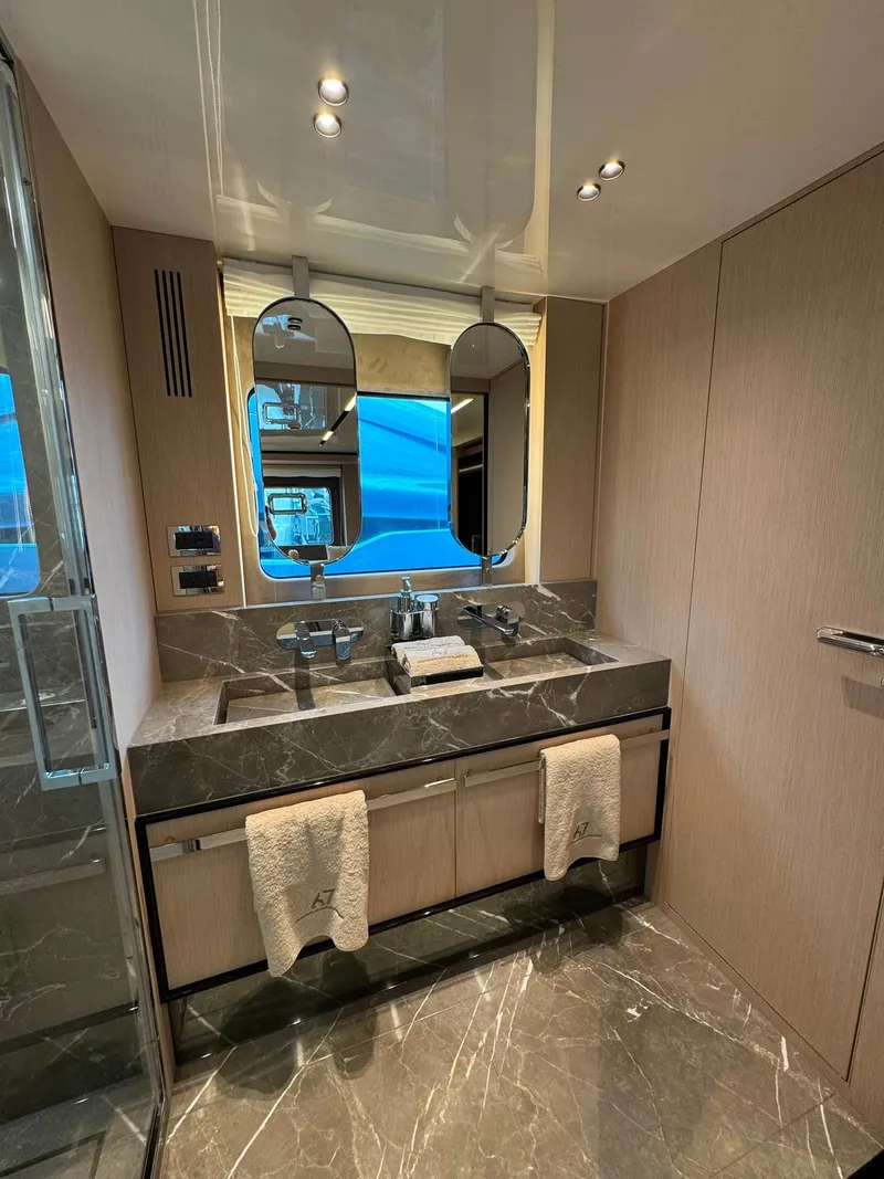 Slide: The Image of Luxurious bathroom with double sinks, marble surfaces, and large mirrors. - 18