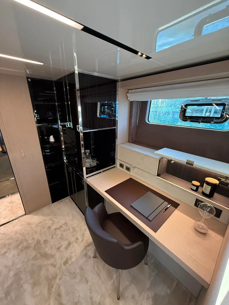 Slide: The Image of Luxurious interior with a desk, chair, and window in a Cranchi Sessantassette 67 yacht. - 19