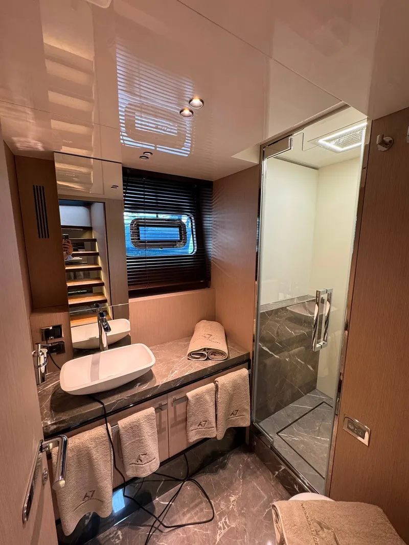 Slide: The Image of Luxurious bathroom with sink, towels, and shower on a Cranchi Sessantassette 67 yacht. - 23