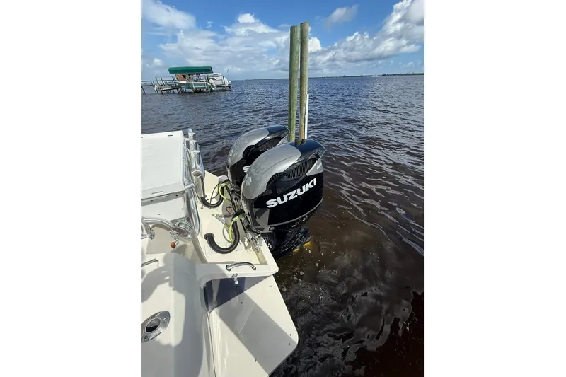 Slide: The Image of 2004 Intrepid 348 Walkaround with Suzuki outboard motors on a sunny day. - 20