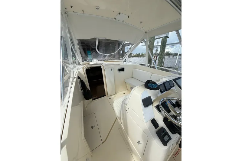 Slide: The Image of 2004 Intrepid 348 Walkaround boat interior with helm, seating, and navigation equipment. - 34
