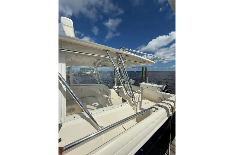 Slide: The Image of 2004 Intrepid 348 Walkaround boat docked under a clear blue sky. - 16