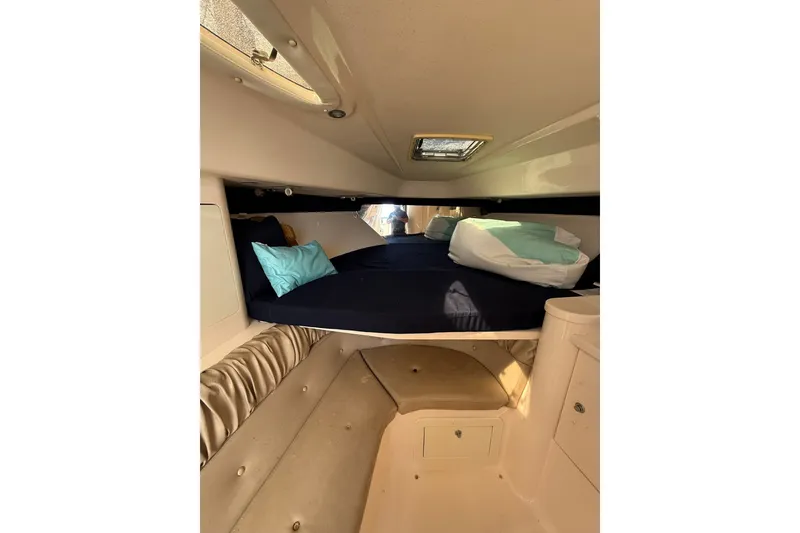 Slide: The Image of Interior cabin of 2004 Intrepid 348 Walkaround boat with cozy bedding and storage. - 40