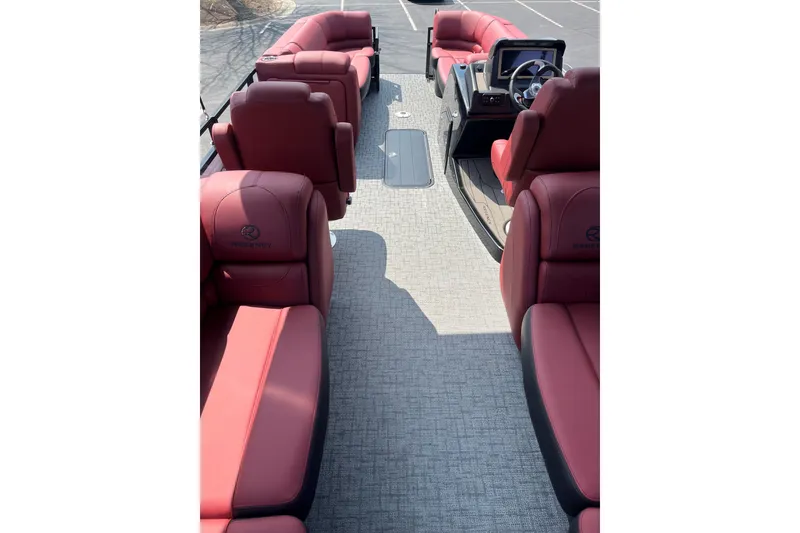 Slide: The Image of Luxurious 2027 Regency 230DL3 boat interior with red seating and modern dashboard. - 2