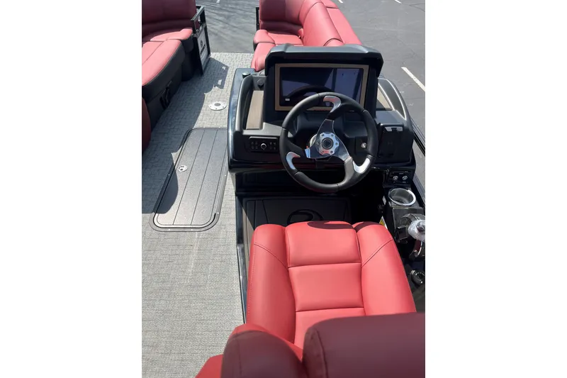 Slide: The Image of 2027 Regency 230DL3 boat interior with red seating and modern steering console. - 3
