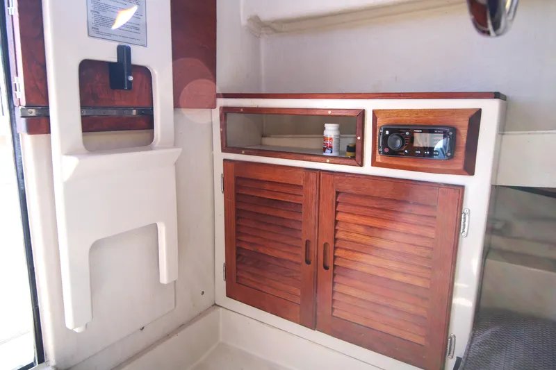 Slide: The Image of Interior of 2005 Ranger Tugs R-21 with wooden cabinets and stereo system. - 17