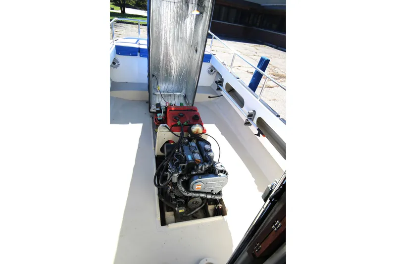 Slide: The Image of 2005 Ranger Tugs R-21 boat engine compartment with visible engine and open hatch. - 10