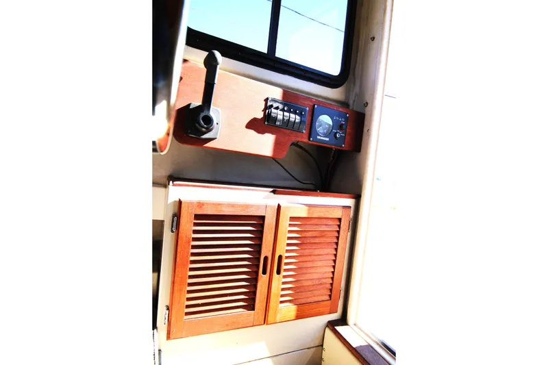 Slide: The Image of Interior of 2005 Ranger Tugs R-21 boat with wooden cabinet and control panel. - 18