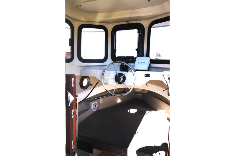 Slide: The Image of Interior helm of 2005 Ranger Tugs R-21 with steering wheel and Garmin device. - 15