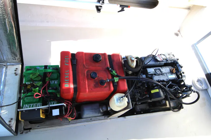 Slide: The Image of Engine compartment of 2005 Ranger Tugs R-21 with diesel fuel tank and battery setup. - 11
