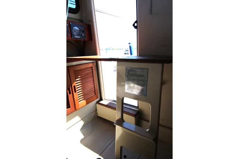Slide: The Image of Interior view of 2005 Ranger Tugs R-21 with wooden cabinetry and control panel. - 20