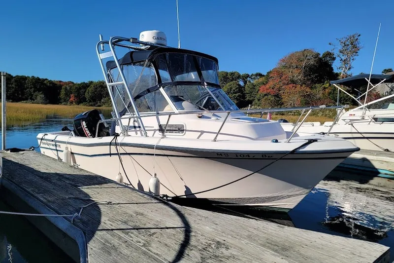 Slide: The Image of 1999 Grady-White Adventure 208 boat docked on a sunny day. - 8