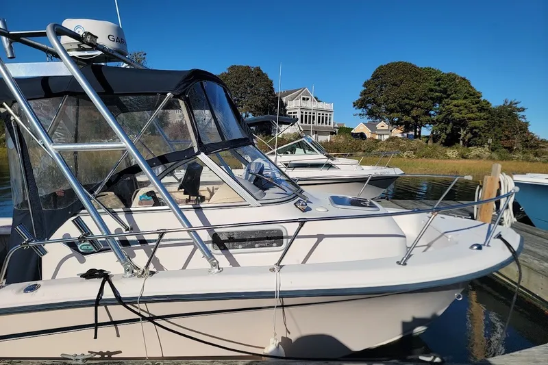 Slide: The Image of 1999 Grady-White Adventure 208 boat docked on a sunny day. - 13