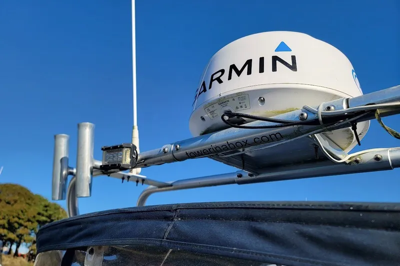 Slide: The Image of Garmin radar on 1999 Grady-White Adventure 208 boat against clear blue sky. - 4