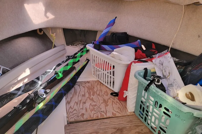 Slide: The Image of Interior of 1999 Grady-White Adventure 208 boat with fishing gear and storage baskets. - 10