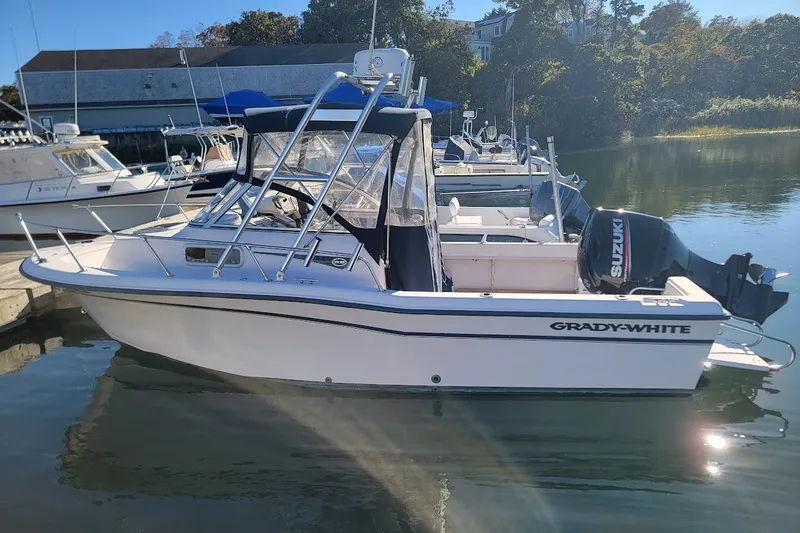 Slide: The Image of 1999 Grady-White Adventure 208 boat docked with Suzuki outboard motor. - 9