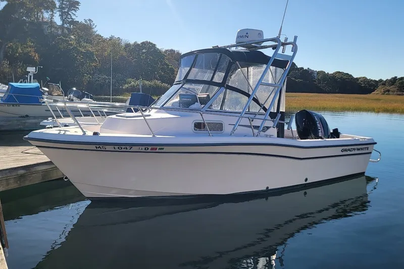 The Image of 1999 Grady-White Adventure 208 boat docked on calm water, clear day. - 0
