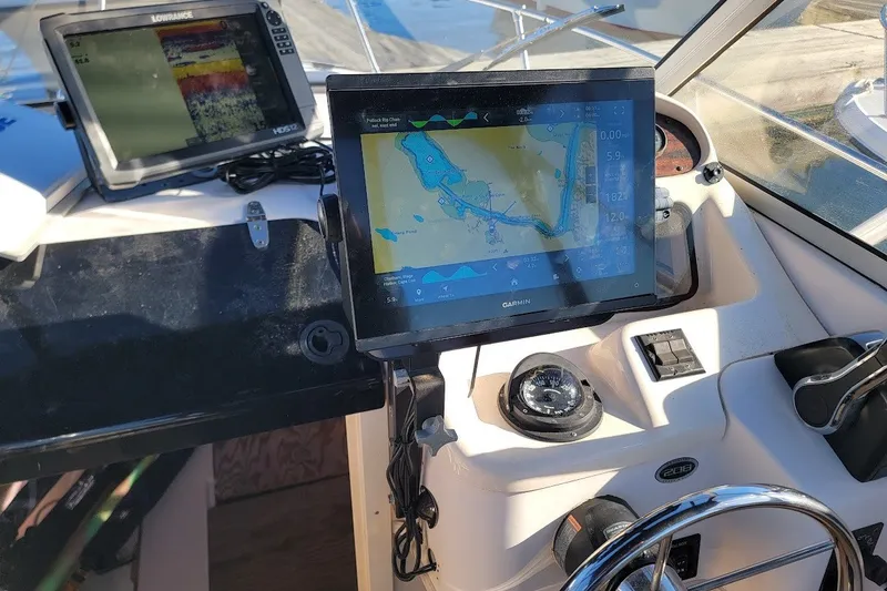 Slide: The Image of Boat dashboard with navigation screens on a 1999 Grady-White Adventure 208. - 3
