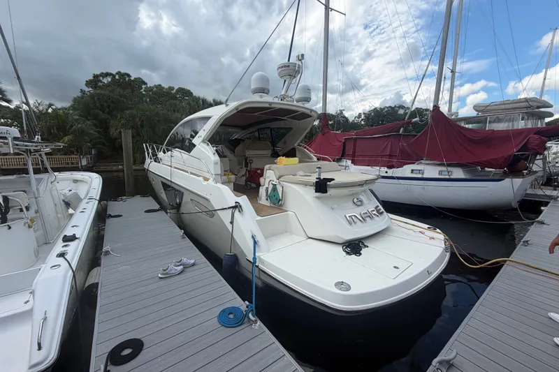 The Image of 2013 Cranchi M 44 HT yacht docked at marina under cloudy sky. - 1