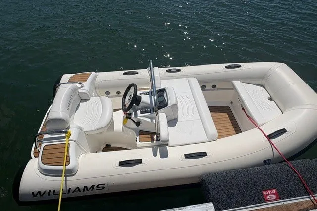 Slide: The Image of 2021 Williams Jet Tenders 325 Turbo Jet boat docked on water. - 3