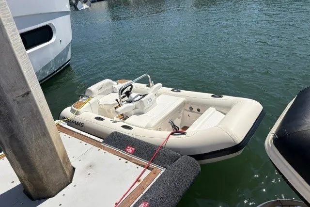 The Image of 2021 Williams Jet Tenders 325 Turbo Jet docked on calm water. - 2