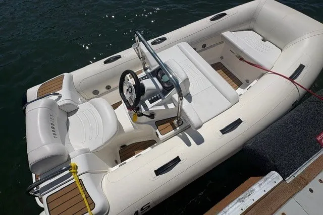 Slide: The Image of 2021 Williams Jet Tenders 325 Turbo Jet boat docked on water. - 5