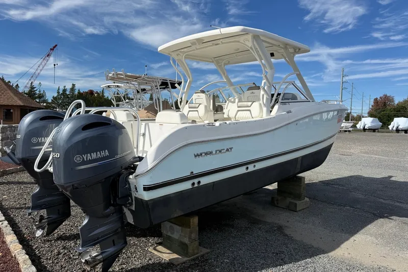 Slide: The Image of 2022 World Cat 255 DC boat with twin Yamaha engines on display outdoors. - 1