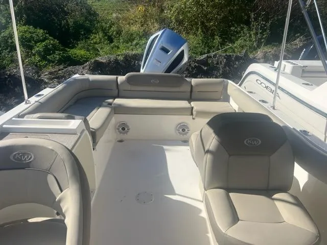 Slide: The Image of 2020 Key West 239 DFS boat interior with cushioned seating and outboard motor. - 9