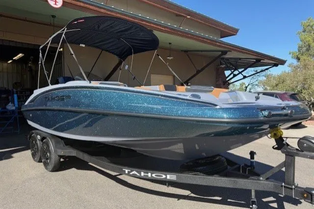 The Image of 2027 Tahoe 2150 boat with canopy on trailer, parked outside a building. - 0