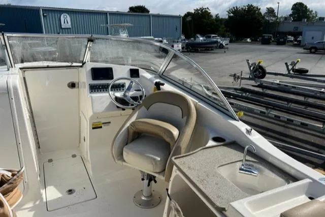 Slide: The Image of 2019 Key West 239 DFS boat interior with steering wheel and seating. - 13