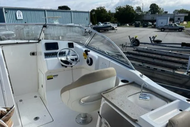 Slide: The Image of 2019 Key West 239 DFS boat interior with steering wheel and seating. - 15