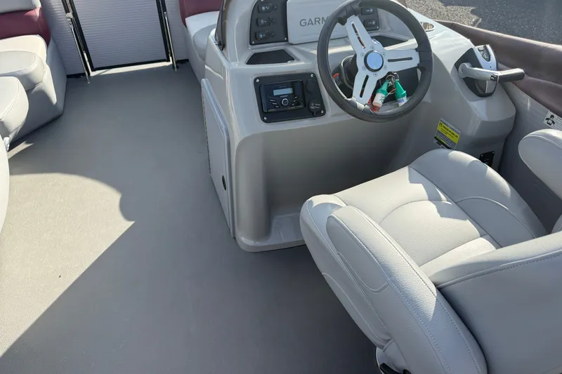 Slide: The Image of Interior view of 2021 Manitou Aurora 21 boat with steering wheel and seating. - 8