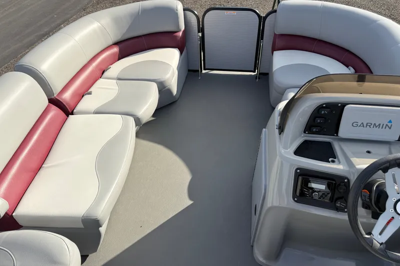 Slide: The Image of 2021 Manitou Aurora 21 boat interior with Garmin dashboard and spacious seating. - 15
