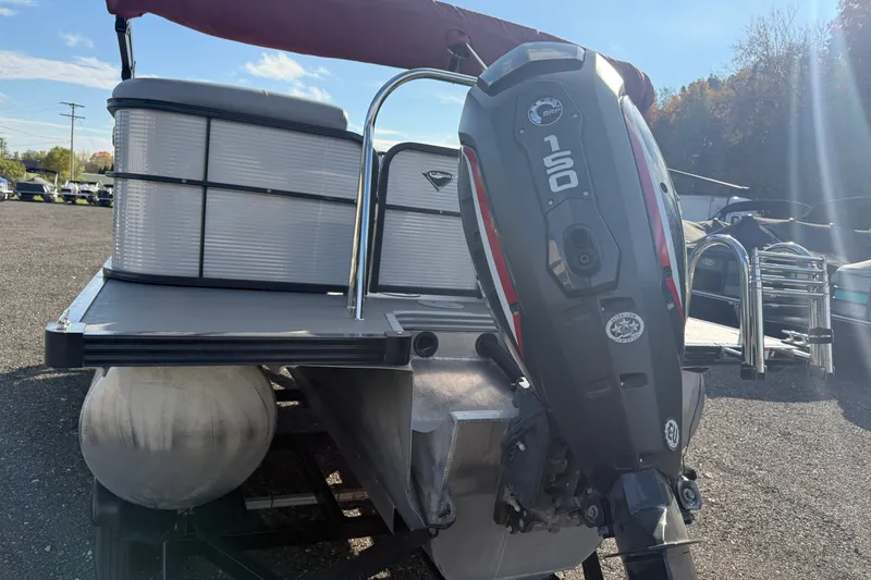 Slide: The Image of 2021 Manitou Aurora 21 pontoon boat with a 150 HP outboard motor. - 3