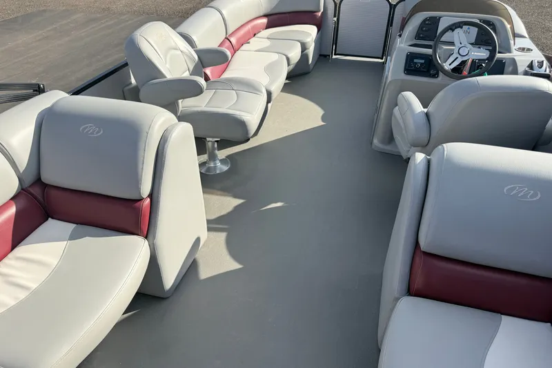 Slide: The Image of Luxurious interior of 2021 Manitou Aurora 21 pontoon boat with plush seating and modern dashboard. - 16