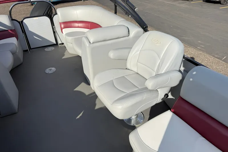 Slide: The Image of Luxurious seating on 2021 Manitou Aurora 21 pontoon boat, featuring white and red upholstery. - 6