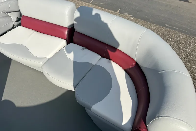 Slide: The Image of 2021 Manitou Aurora 21 boat seating with white and maroon upholstery. - 5