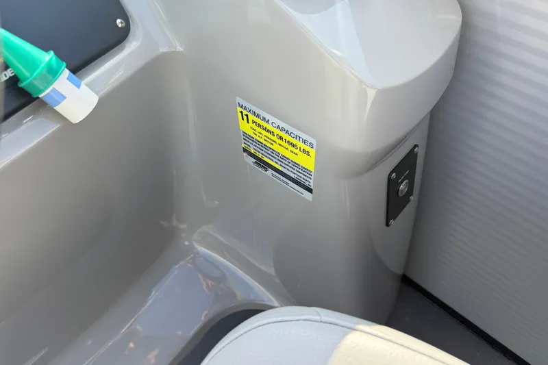 Slide: The Image of Interior of 2021 Manitou Aurora 21 showing capacity label and seating area. - 10