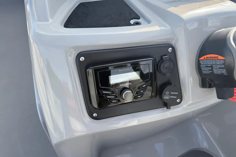 Slide: The Image of Control panel of 2021 Manitou Aurora 21 featuring Kicker media center and warning label. - 12