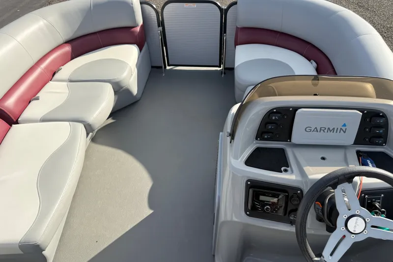 Slide: The Image of 2021 Manitou Aurora 21 boat interior with Garmin dashboard and spacious seating. - 14