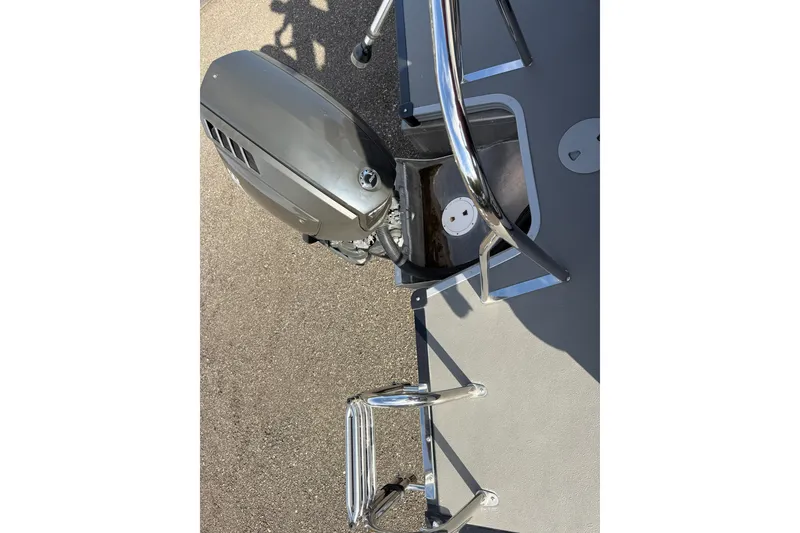 Slide: The Image of 2021 Manitou Aurora 21 boat with outboard motor and ladder. - 17