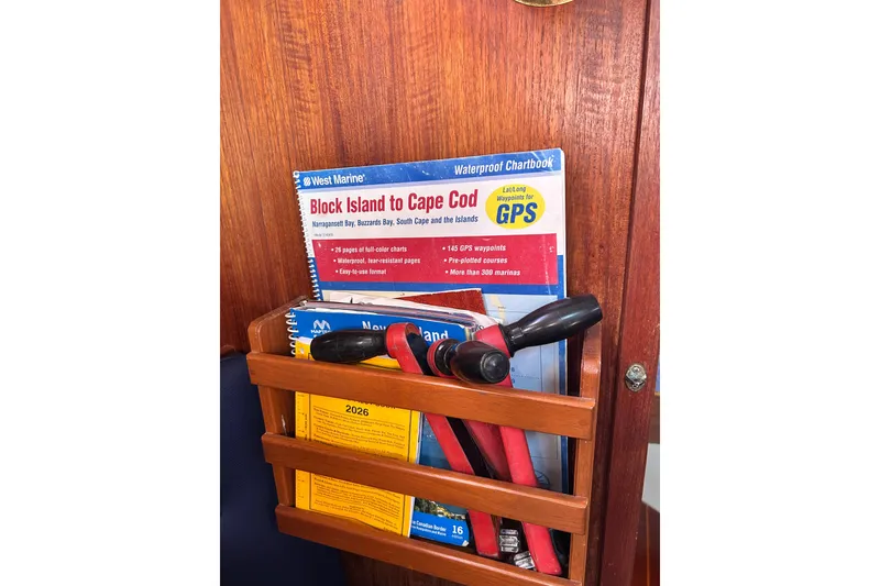 Slide: The Image of Nautical chartbooks and tools on a Catalina 34 sailboat, 1988 model. - 21