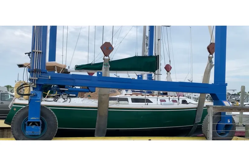 Slide: The Image of 1988 Catalina 34 sailboat in dry dock, green hull, marina setting. - 56