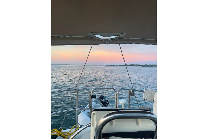 Slide: The Image of Sailing on a 1988 Catalina 34 at sunset, overlooking calm waters and a colorful sky. - 40