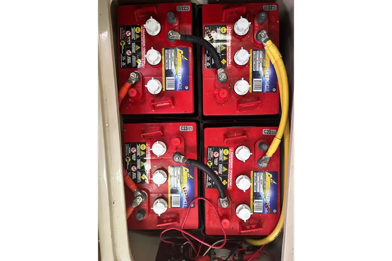 Slide: The Image of Four red marine batteries in a 1988 Catalina 34 sailboat. - 49