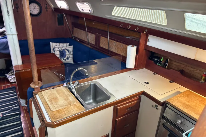 Slide: The Image of Interior of 1988 Catalina 34 sailboat with kitchen and seating area. - 24